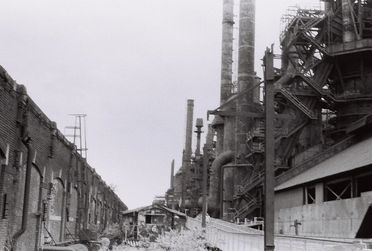 black-and-white photo of a steel mill extending into the distance