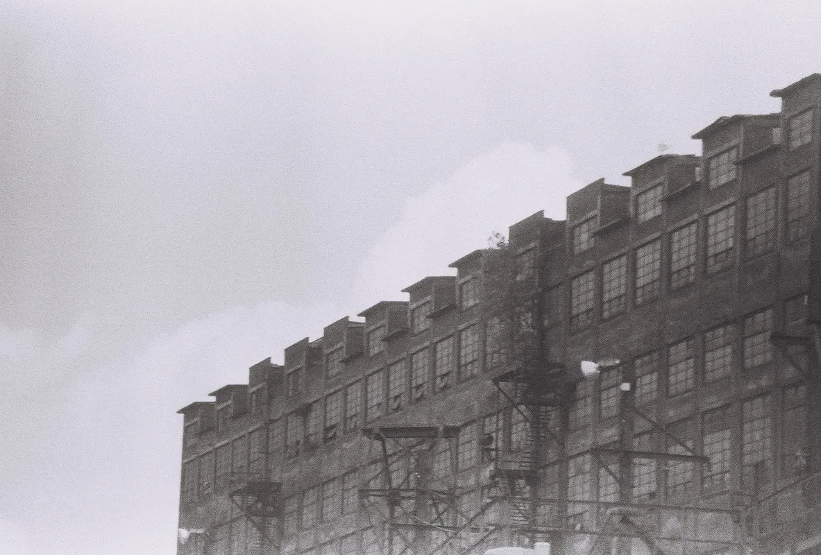 a warehouse with fire escapes and electric poles