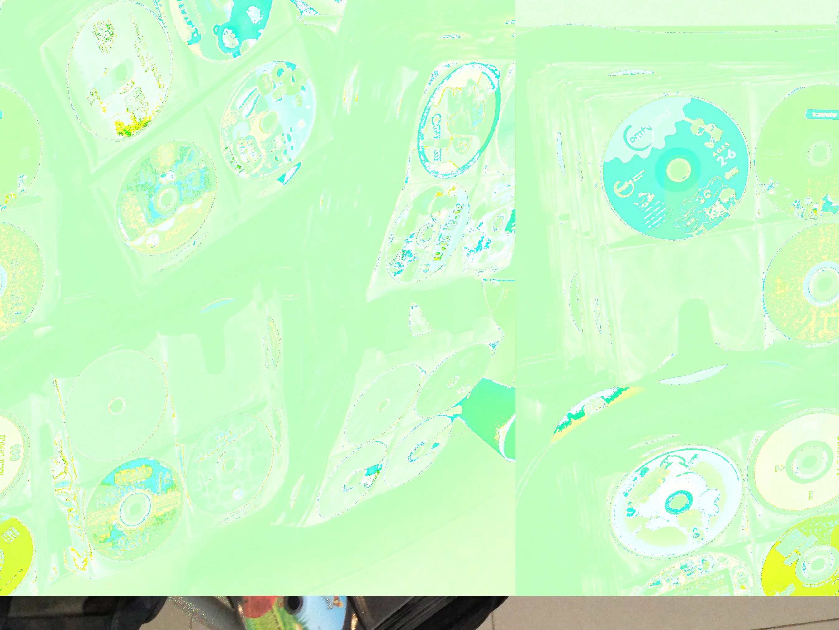 a datamoshed image of CD binders