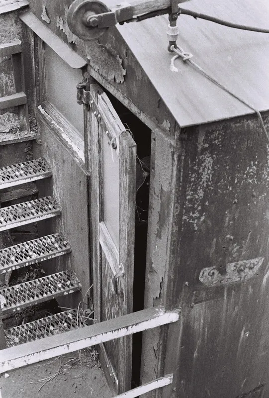 a wooden door hangning slightly ajar