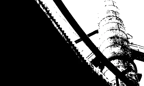 metal tower jutting into sky, mostly obscured by underside of a pipe