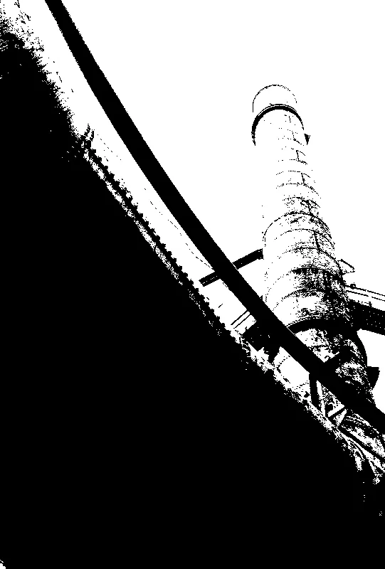 metal tower jutting into sky, mostly obscured by underside of a pipe