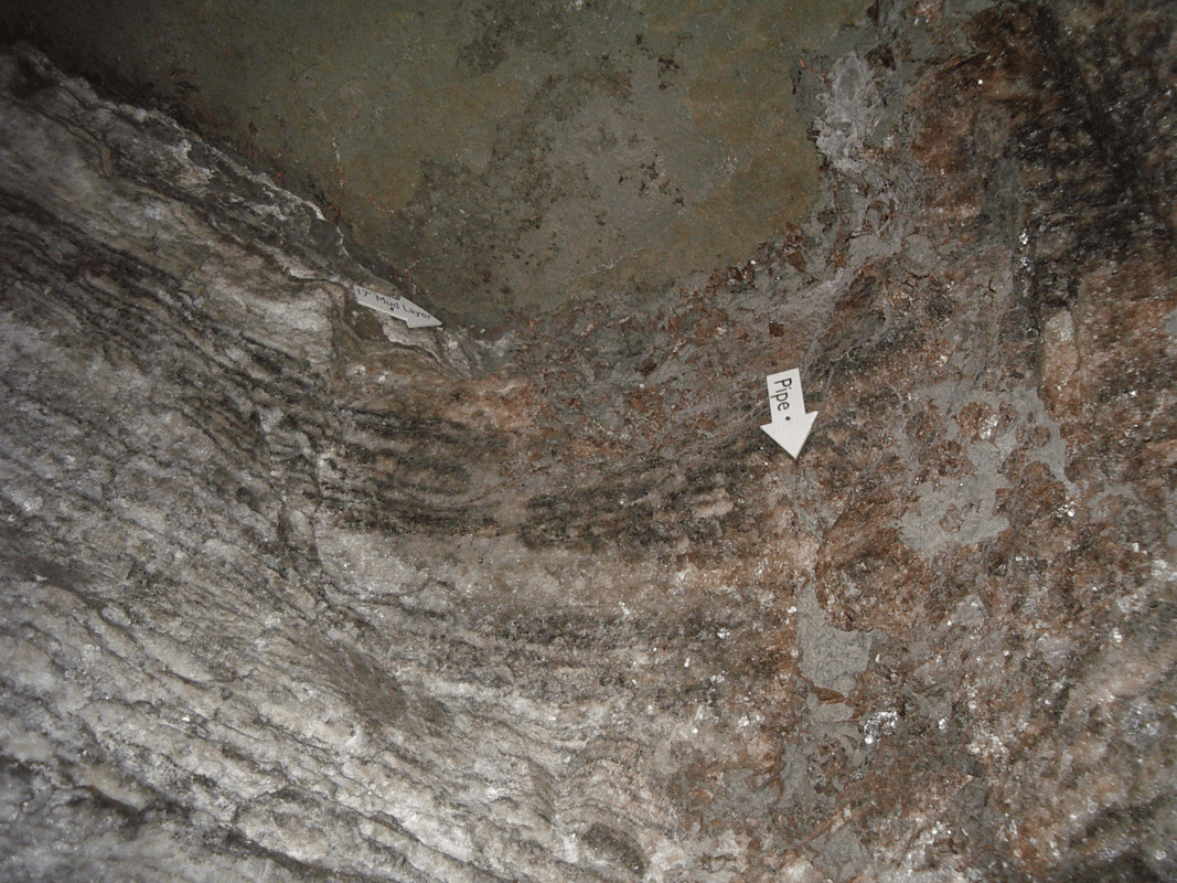 The wall of a salt mine with a white arrow ponting down labeled "Pipe"