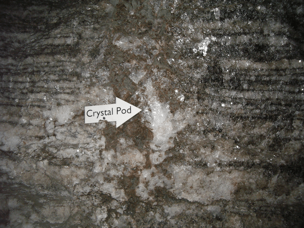 Wall of a salt mine with a wire arrow labeled "Crystal Pod"