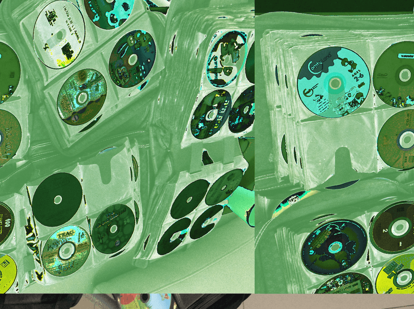a datamoshed image of CD binders