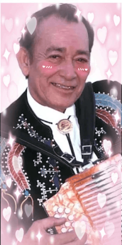 edit of tejano music legend flaco jiménez surrounded by pink hearts with a pink vignette and kawaii blush marks drawn on his cheeks