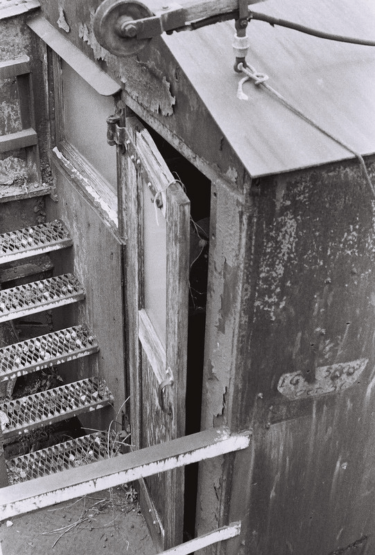 a wooden door hanging slightly ajar