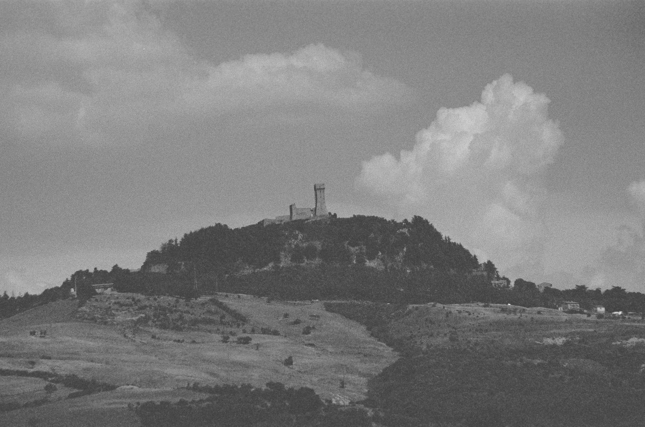 a fortress on a hill in the Tuscan countryside